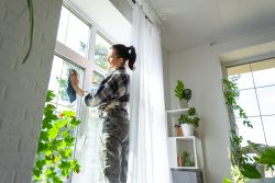 woman manually washes the window of the house with 2026 01 05 23 23 54 utc